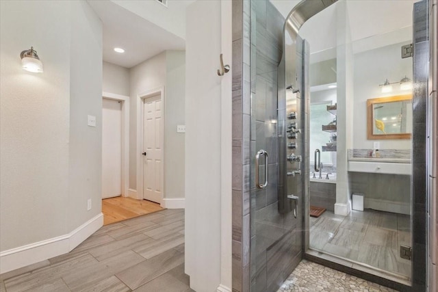 1345 Stillwater Rd, Waco, TX 76708 - full bathroom featuring wood finish floors, baseboards, a stall shower, recessed lighting, and vanity