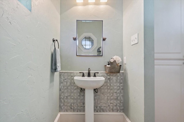 1345 Stillwater Rd, Waco, TX 76708 - bathroom featuring tile walls and a wainscoted wall
