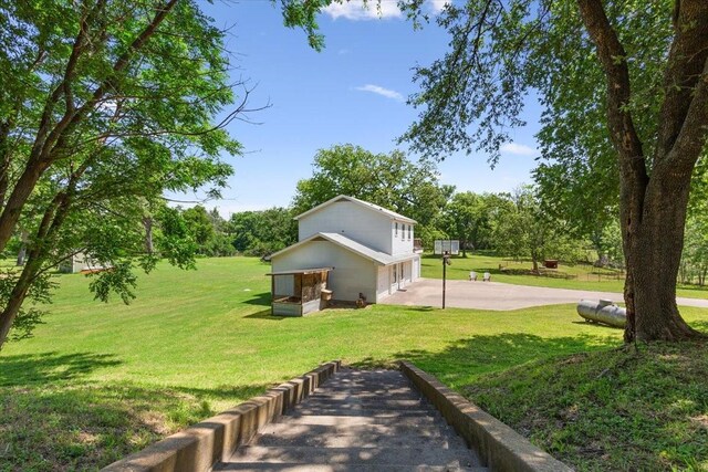 1345 Stillwater Rd, Waco, TX 76708 - view of green lawn with a garage and concrete driveway