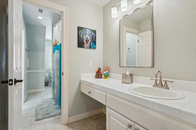 1345 Stillwater Rd, Waco, TX 76708 - full bath with vanity, tile patterned flooring, and baseboards