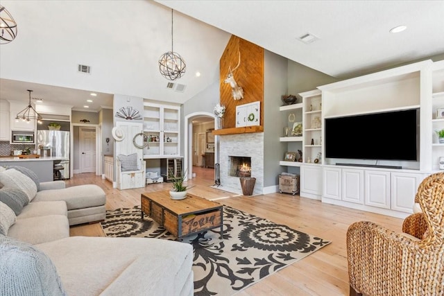 1345 Stillwater Rd, Waco, TX 76708 - living room with high vaulted ceiling, a large fireplace, a chandelier, light wood finished floors, and recessed lighting