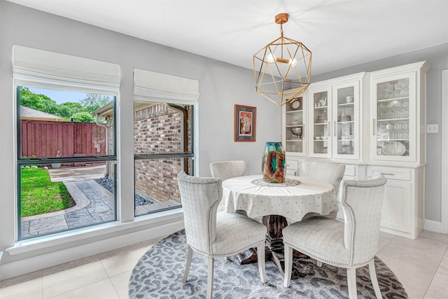 4218 High Star Ln, Dallas, TX 75287 - dining area featuring a chandelier, light tile patterned floors, and baseboards