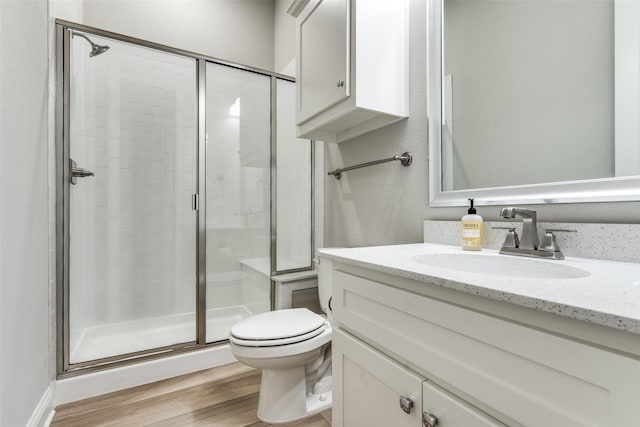 12523 Royal Oaks Ln, Farmers Branch, TX 75234 - full bath with a stall shower, toilet, wood finished floors, and vanity