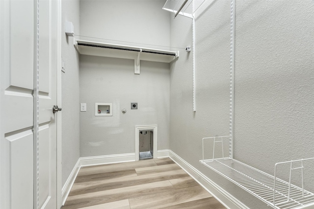 12523 Royal Oaks Ln, Farmers Branch, TX 75234 - washroom featuring hookup for a gas dryer, hookup for an electric dryer, light wood-style flooring, washer hookup, and baseboards