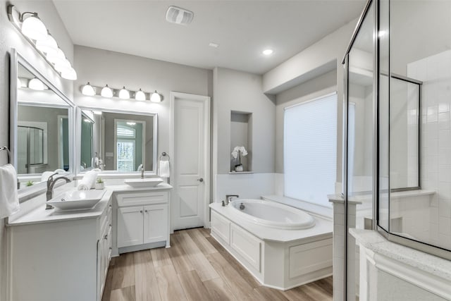 12523 Royal Oaks Ln, Farmers Branch, TX 75234 - full bath with a garden tub, a tile shower, vanity, and wood finished floors