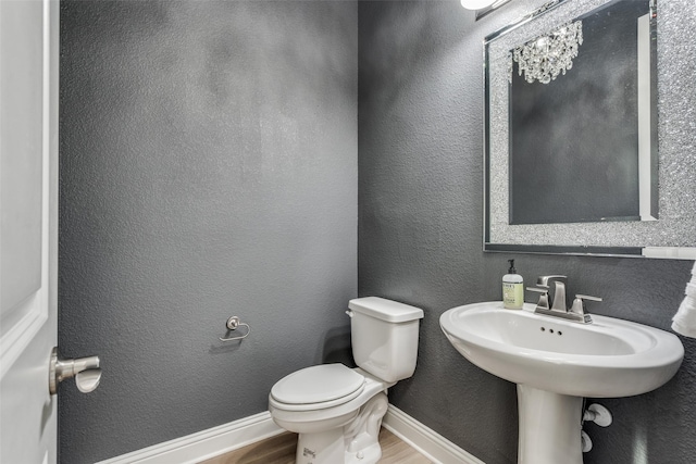 12523 Royal Oaks Ln, Farmers Branch, TX 75234 - half bathroom with wood finished floors and toilet
