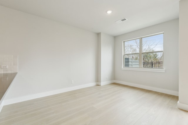 8289 Emsworth Dr, Dallas, TX 75231 - spare room featuring light wood finished floors, baseboards, and recessed lighting