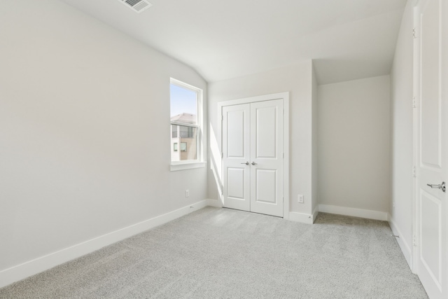 8289 Emsworth Dr, Dallas, TX 75231 - unfurnished bedroom featuring carpet, baseboards, a closet, and lofted ceiling
