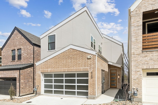 8289 Emsworth Dr, Dallas, TX 75231 - view of front of property with brick siding, driveway, stucco siding, and a garage
