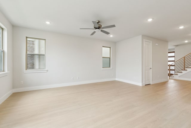8289 Emsworth Dr, Dallas, TX 75231 - unfurnished room featuring healthy amount of natural light, stairway, light wood finished floors, recessed lighting, and a ceiling fan