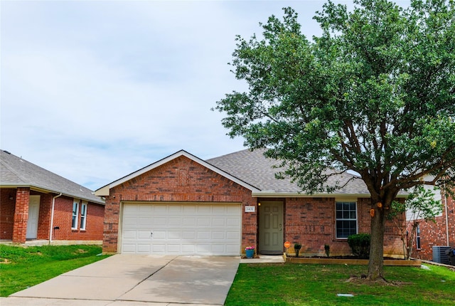 1431 Puerto Lago Dr, Little Elm, TX 75068 - view of front of house with brick siding, driveway, central AC, an attached garage, and roof with shingles