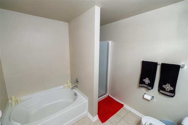 1431 Puerto Lago Dr, Little Elm, TX 75068 - bathroom featuring tile patterned flooring, a bath, a shower stall, baseboards, and toilet