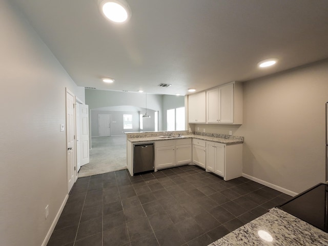 kitchen featuring stainless steel dishwasher, a peninsula, arched walkways, a sink, and white cabinets