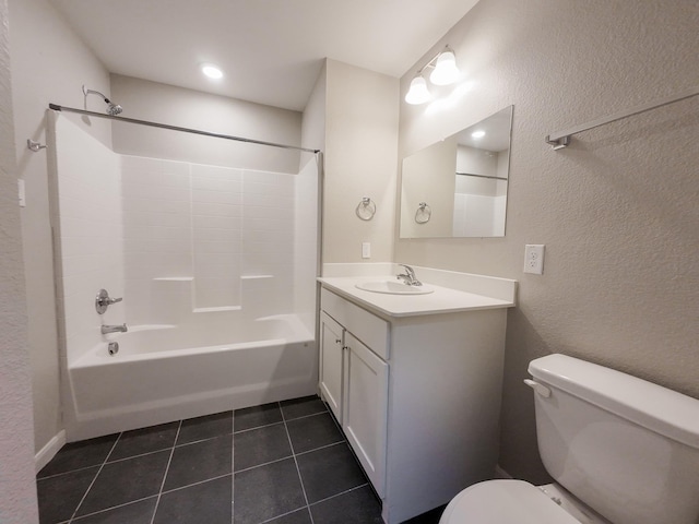 bathroom with toilet, tile patterned floors, vanity, bathing tub / shower combination, and a textured wall