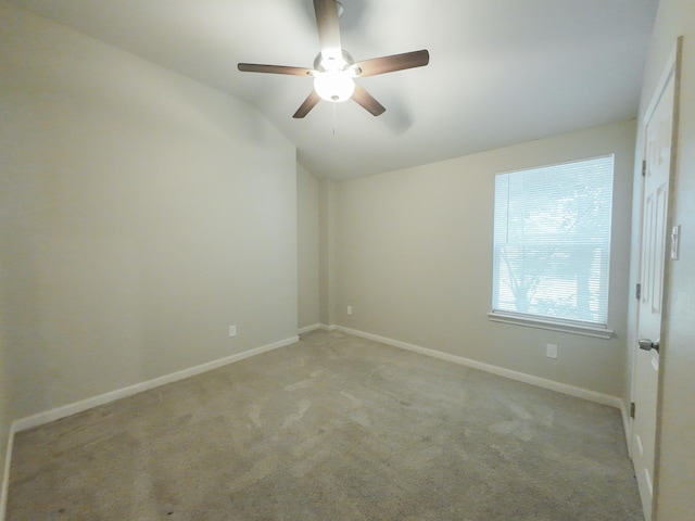 unfurnished room featuring lofted ceiling, light carpet, ceiling fan, and baseboards