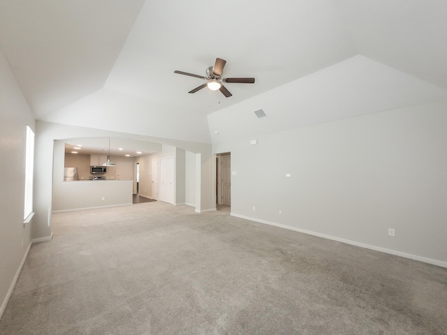 unfurnished living room featuring lofted ceiling, ceiling fan, baseboards, light colored carpet, and recessed lighting