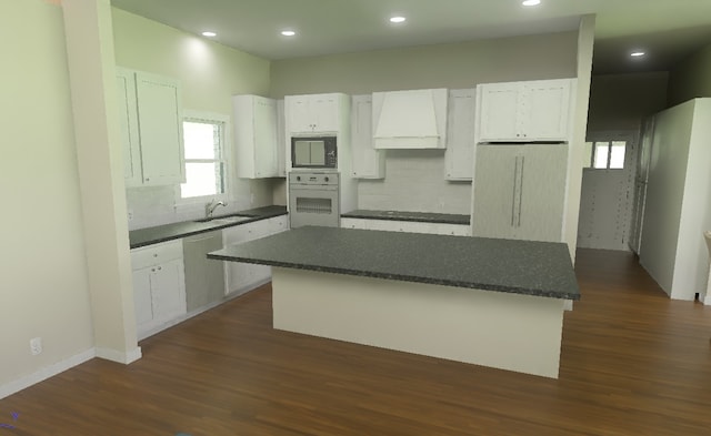 LOT11 Hemlock Pr Unit 1262, Brashear, TX 75420 - kitchen featuring oven, premium range hood, black microwave, a kitchen island, and white cabinetry