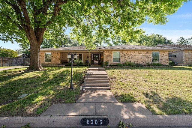 ranch-style home featuring brick siding