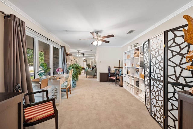 sitting room featuring ceiling fan, crown molding, and carpet flooring