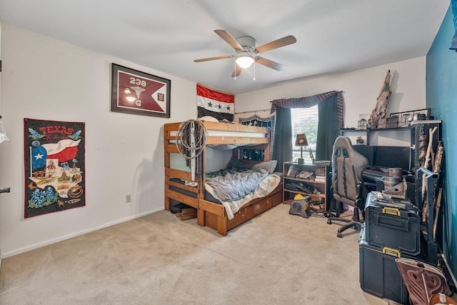 bedroom featuring carpet flooring, a desk, baseboards, and a ceiling fan
