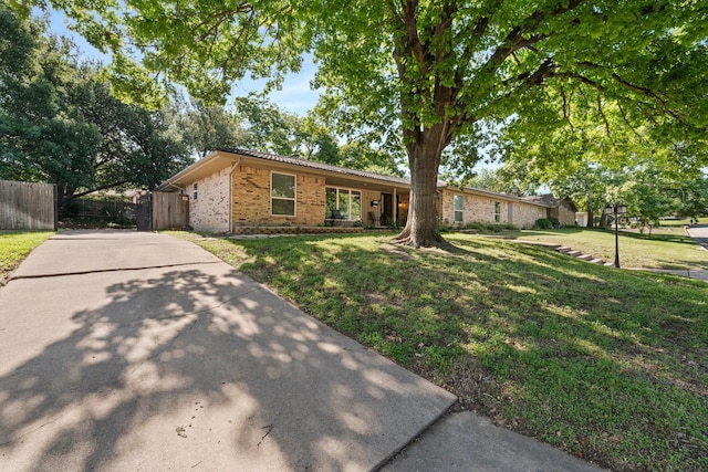 ranch-style home with brick siding and concrete driveway