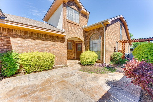 3817 Roman Ct, Plano, TX 75023 - view of front facade with brick siding, a patio area, and a pergola
