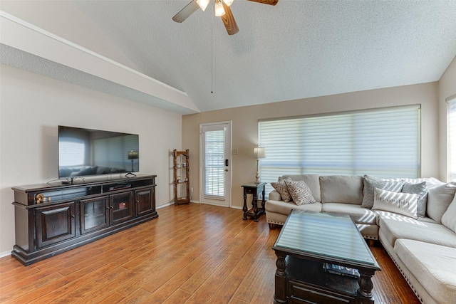 3817 Roman Ct, Plano, TX 75023 - living area featuring ceiling fan, light wood-type flooring, a textured ceiling, baseboards, and high vaulted ceiling