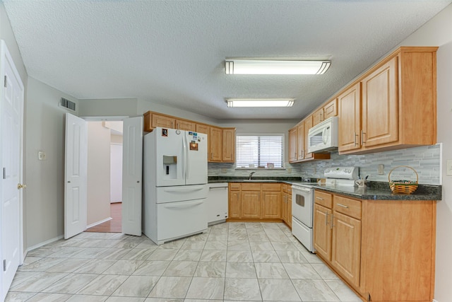 3817 Roman Ct, Plano, TX 75023 - kitchen featuring white appliances, light marble finish floors, dark countertops, backsplash, and a textured ceiling