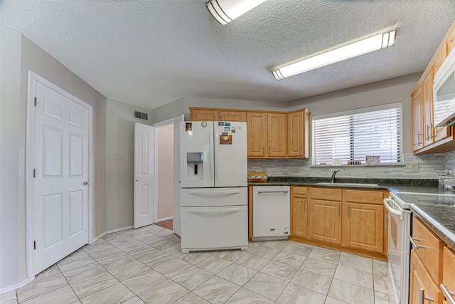 3817 Roman Ct, Plano, TX 75023 - kitchen featuring white appliances, light marble finish flooring, a sink, dark countertops, and decorative backsplash