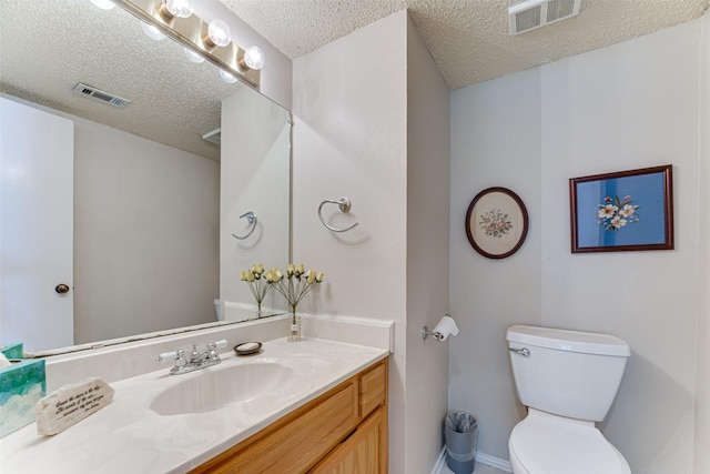 3817 Roman Ct, Plano, TX 75023 - bathroom featuring a textured ceiling, toilet, vanity, and baseboards