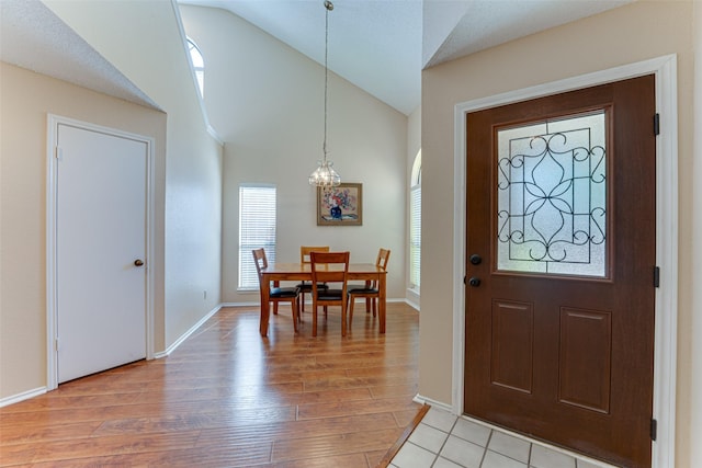 3817 Roman Ct, Plano, TX 75023 - foyer entrance featuring light wood-style floors, baseboards, and high vaulted ceiling
