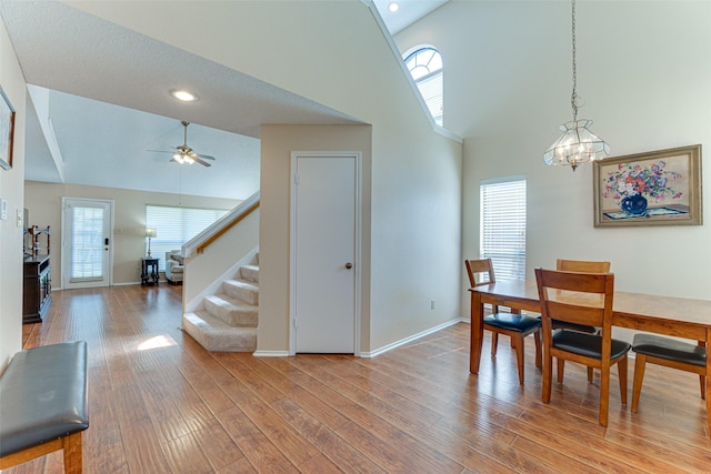 3817 Roman Ct, Plano, TX 75023 - dining area with high vaulted ceiling, stairway, baseboards, a chandelier, and plenty of natural light