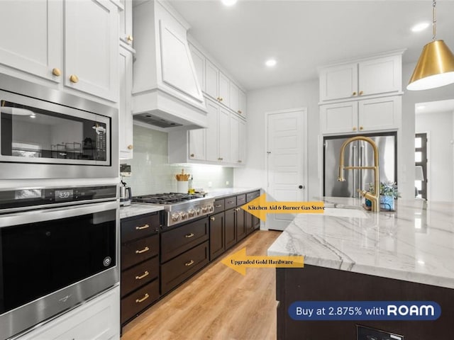3536 E Cheney Ave, Celina, TX 75009 - kitchen with stainless steel appliances, white cabinets, custom range hood, and recessed lighting