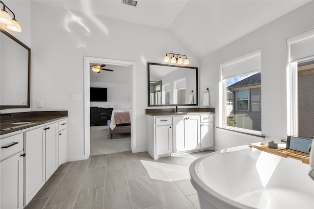 3536 E Cheney Ave, Celina, TX 75009 - bathroom featuring vaulted ceiling, a soaking tub, ceiling fan, and two vanities