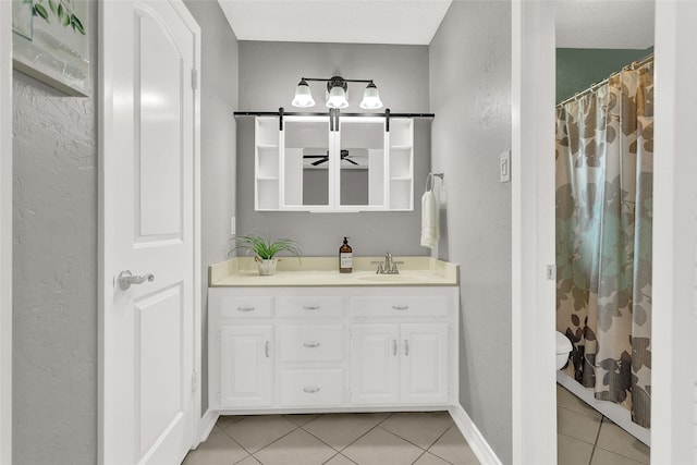8811 Pheasant Dr, Chandler, TX 75758 - bathroom with tile patterned floors, vanity, a textured wall, toilet, and baseboards