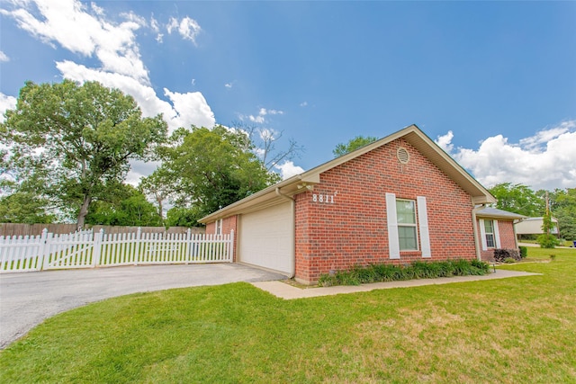 8811 Pheasant Dr, Chandler, TX 75758 - view of side of home with brick siding, a garage, and driveway