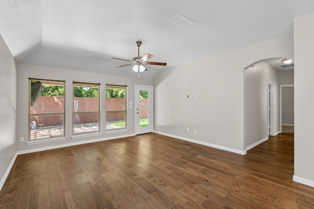 409 Bird Creek Dr, Little Elm, TX 75068 - empty room with arched walkways, ceiling fan, lofted ceiling, dark wood-style flooring, and baseboards