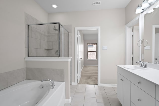 409 Bird Creek Dr, Little Elm, TX 75068 - bathroom with tile patterned floors, a garden tub, vanity, baseboards, and a tile shower