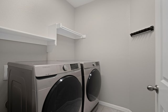 409 Bird Creek Dr, Little Elm, TX 75068 - laundry area with washing machine and clothes dryer, light tile patterned floors, and baseboards