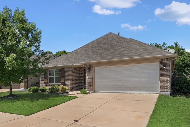 409 Bird Creek Dr, Little Elm, TX 75068 - ranch-style home with brick siding, a front yard, driveway, and a shingled roof