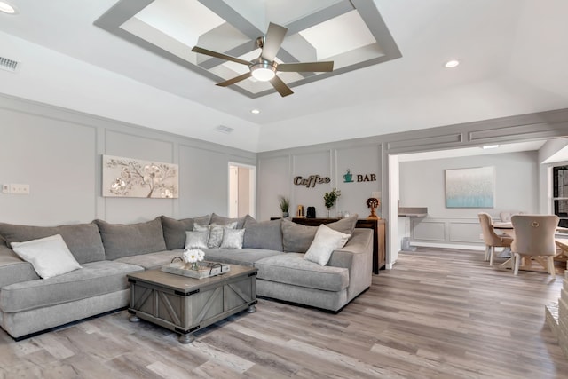 7108 Bermuda Ct, North Richland Hills, TX 76180 - living room featuring a decorative wall, a raised ceiling, light wood-type flooring, a ceiling fan, and recessed lighting
