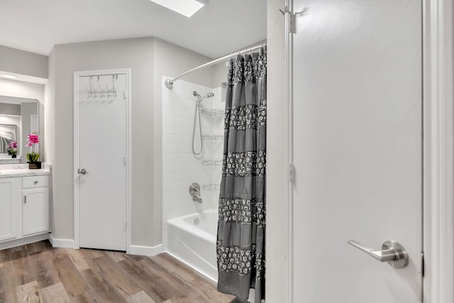 7108 Bermuda Ct, North Richland Hills, TX 76180 - bathroom featuring shower / tub combo with curtain, vanity, wood finished floors, and baseboards