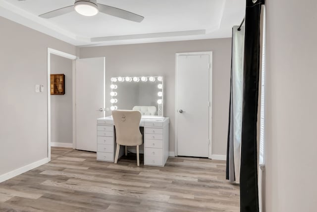 7108 Bermuda Ct, North Richland Hills, TX 76180 - home office featuring a ceiling fan, light wood-type flooring, baseboards, and a raised ceiling