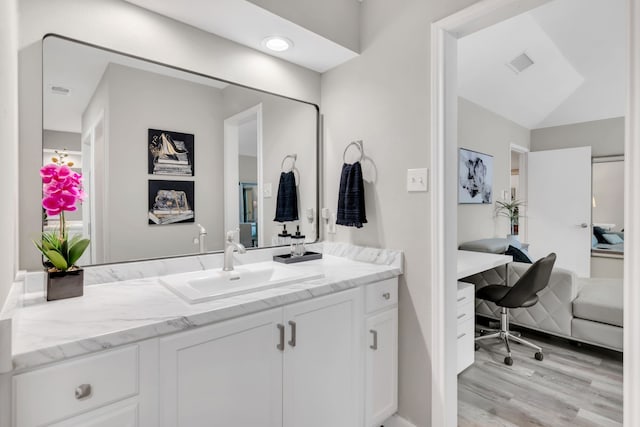 7108 Bermuda Ct, North Richland Hills, TX 76180 - bathroom with wood finished floors and vanity
