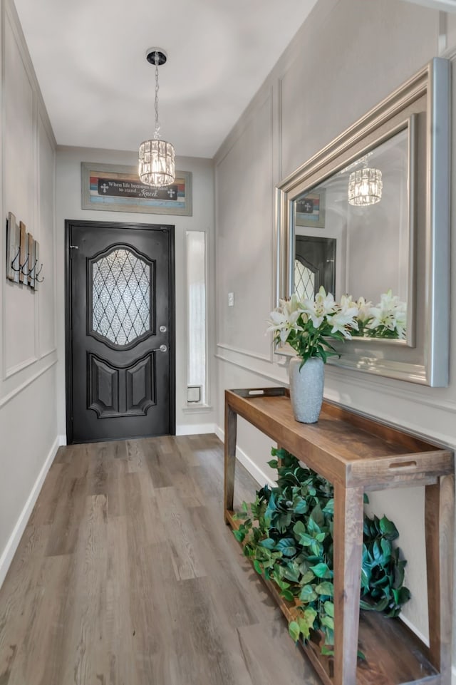 7108 Bermuda Ct, North Richland Hills, TX 76180 - foyer with a chandelier, wood finished floors, and baseboards