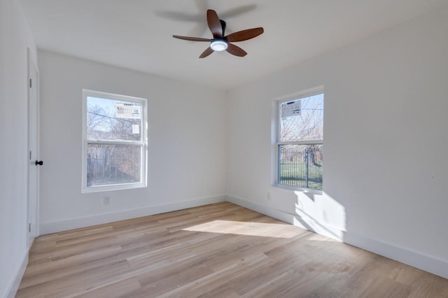 1902 San Antonio St, Grand Prairie, TX 75051 - spare room featuring a ceiling fan, light wood-style floors, and baseboards