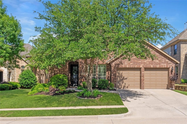 1704 Landon Ln, Mckinney, TX 75071 - obstructed view of property with a garage, brick siding, concrete driveway, and a front yard