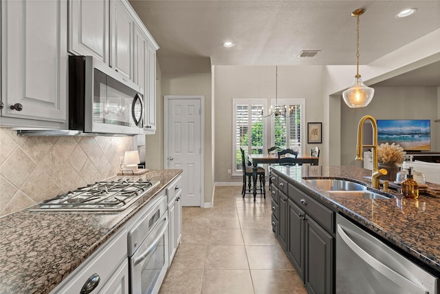 1704 Landon Ln, Mckinney, TX 75071 - kitchen with appliances with stainless steel finishes, a sink, tasteful backsplash, dark stone countertops, and recessed lighting