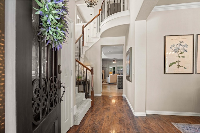1704 Landon Ln, Mckinney, TX 75071 - entrance foyer with stairs, wood finished floors, baseboards, crown molding, and a ceiling fan
