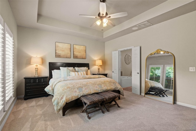 1704 Landon Ln, Mckinney, TX 75071 - bedroom featuring carpet floors, a tray ceiling, baseboards, and connected bathroom